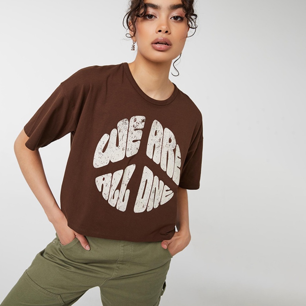 ☀️ 3/$15 Ardene Graphic Print Boxy T-Shirt We Are All One Brown